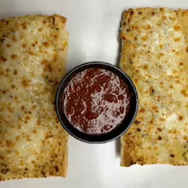 Two rectangular cheese breadsticks with a side of marinara sauce for dipping.