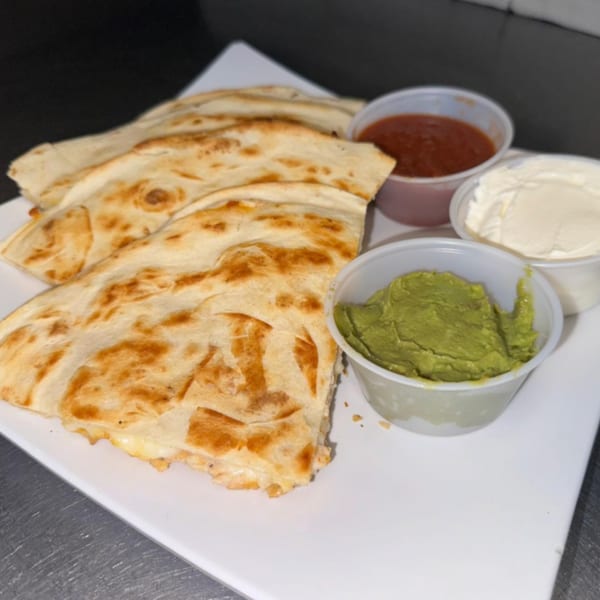 Golden-brown quesadillas with guacamole, salsa, and sour cream on a white plate.
